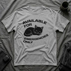 T-Shirt — 'AVAILABLE FOR EMERGENCIES ONLY' Tired Cat Graphic Tee (Tired jokes)