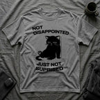 T-Shirt — 'Not Disappointed Just Not Surprised' Tired Cat Graphic Tee (Tired jokes)