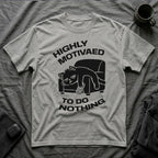 T-Shirt — 'HIGHLY MOTIVATED TO DO NOTHING' Tired Cat Graphic Tee (Tired jokes)