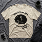 T-Shirt — 'NAPPING MY PROBLEMS AWAY' Tired Cat Graphic Tee (Tired jokes)