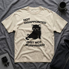 T-Shirt — 'Not Disappointed Just Not Surprised' Tired Cat Graphic Tee (Tired jokes)