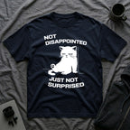 T-Shirt — 'Not Disappointed Just Not Surprised' Tired Cat Graphic Tee (Tired jokes)